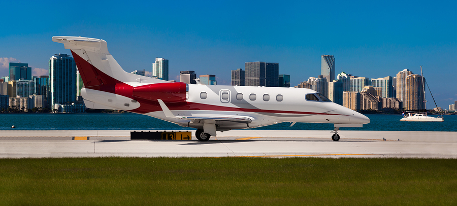 Private jet on the runway with city in the background