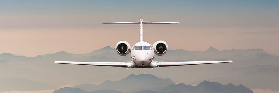 Luxury Airplane fly over clouds and Alps mountain on sunset. Fro